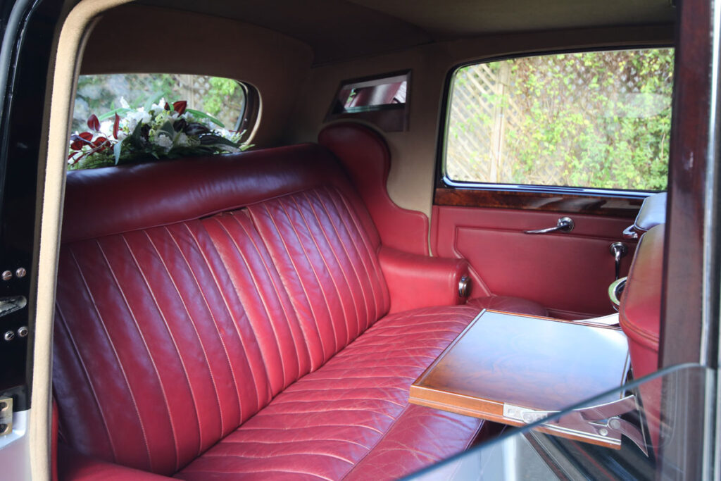 Wedding Car Hire Dorset, 1954 Rolls Royce Silver Dawn, Poppy wedding car Dorset, classic wedding car Dorset, vintage Rolls Royce hire, chauffeur-driven wedding car, red leather wedding car interior, timeless wedding transport, Rolls Royce Shillingstone, elegant bridal car Dorset, heritage wedding vehicle