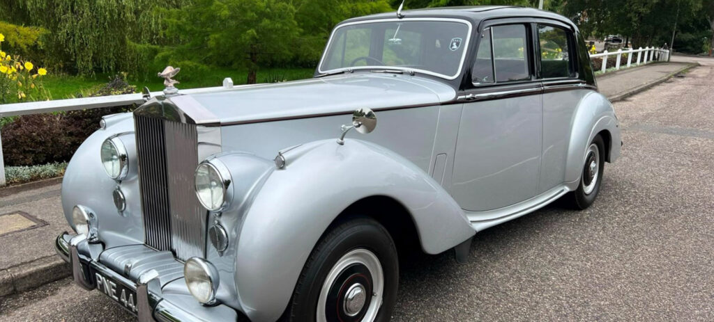 Wedding Car Hire Dorset, 1954 Rolls Royce Silver Dawn, Poppy wedding car Dorset, classic wedding car Dorset, vintage Rolls Royce hire, chauffeur-driven wedding car, red leather wedding car interior, timeless wedding transport, Rolls Royce Shillingstone, elegant bridal car Dorset, heritage wedding vehicle